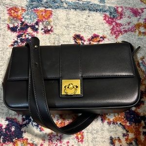 Black shoulder bag with gold colored hardware